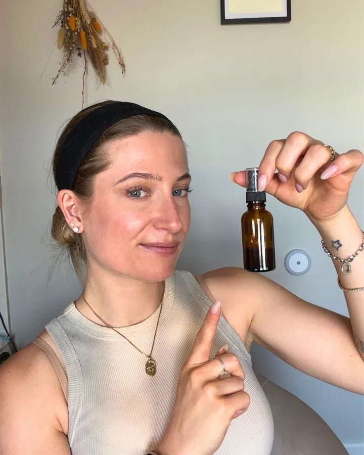 Csilla, Lucid's founder, holding an amber glass bottle